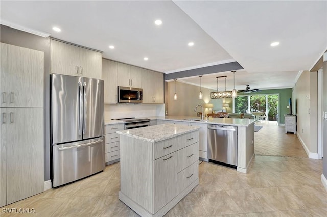 3051 Sandpiper Bay Cir Unit I102, Naples, FL 34112 - kitchen featuring appliances with stainless steel finishes, a peninsula, open floor plan, ornamental molding, and recessed lighting