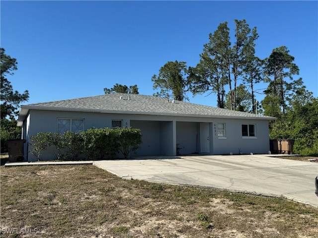 5031 Locke Ln, Lehigh Acres, FL 33973 - view of front of home with stucco siding, roof with shingles, and a patio
