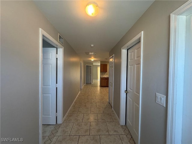 5031 Locke Ln, Lehigh Acres, FL 33973 - hallway featuring baseboards, visible vents, and light tile patterned floors