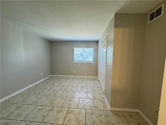 5031 Locke Ln, Lehigh Acres, FL 33973 - unfurnished bedroom with baseboards, visible vents, a closet, and light tile patterned floors