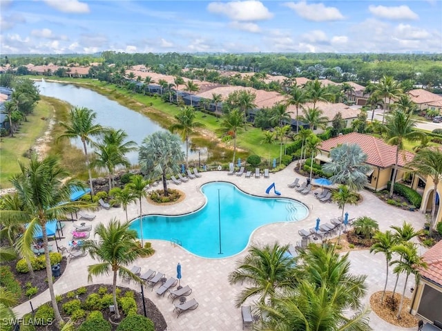 pool featuring a residential view, a patio area, and a water view