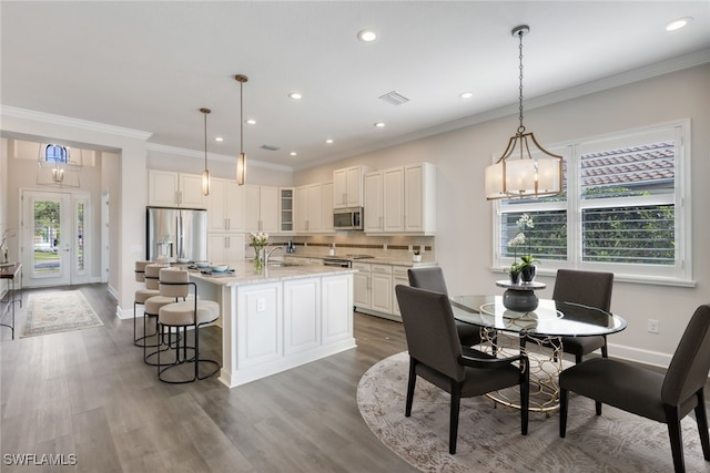 kitchen with dark wood finished floors, tasteful backsplash, stainless steel appliances, and white cabinetry