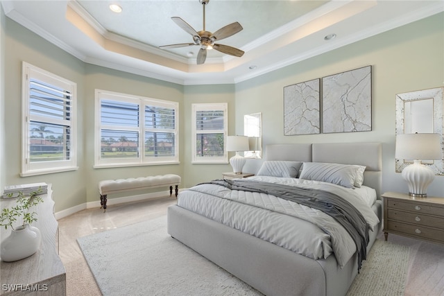 bedroom featuring a tray ceiling, carpet, baseboards, and ornamental molding