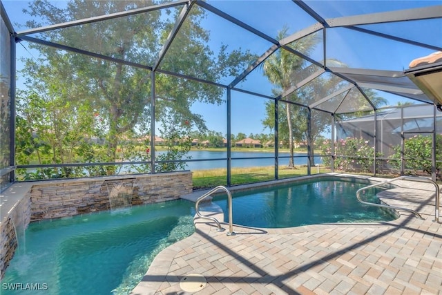 pool with glass enclosure, a patio area, and a water view