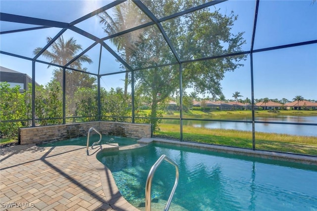 pool featuring glass enclosure, a patio, and a water view