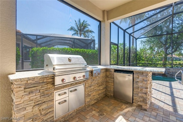 view of patio with an outdoor kitchen, area for grilling, and a lanai