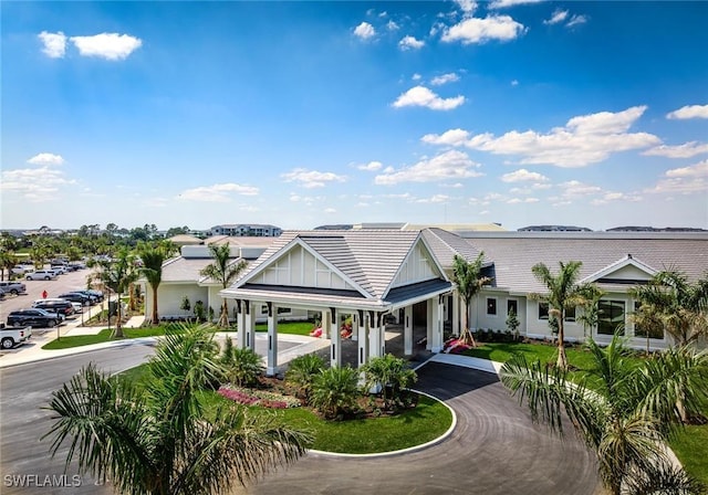15927 Grassland Ln Unit 4122, Punta Gorda, FL 33982 - view of front facade featuring asphalt driveway, a tiled roof, and a porch
