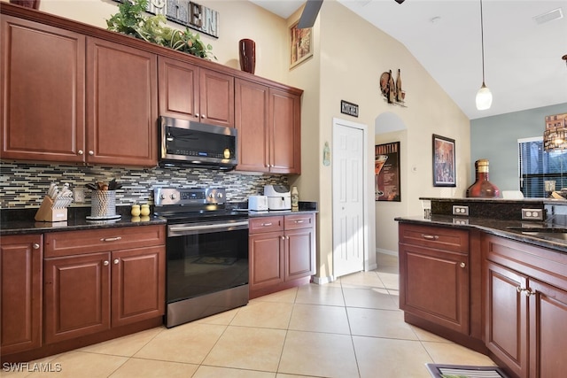 2728 Beach Pkwy W, Cape Coral, FL 33914 - kitchen with appliances with stainless steel finishes, tasteful backsplash, hanging light fixtures, light tile patterned flooring, and high vaulted ceiling