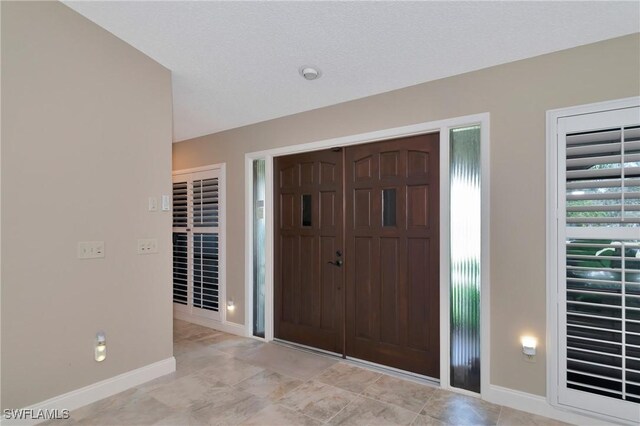 225 Brighton Ct, Englewood, FL 34223 - entryway featuring baseboards