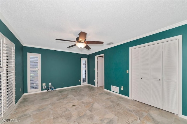 225 Brighton Ct, Englewood, FL 34223 - unfurnished bedroom featuring a textured ceiling, visible vents, a closet, and multiple windows