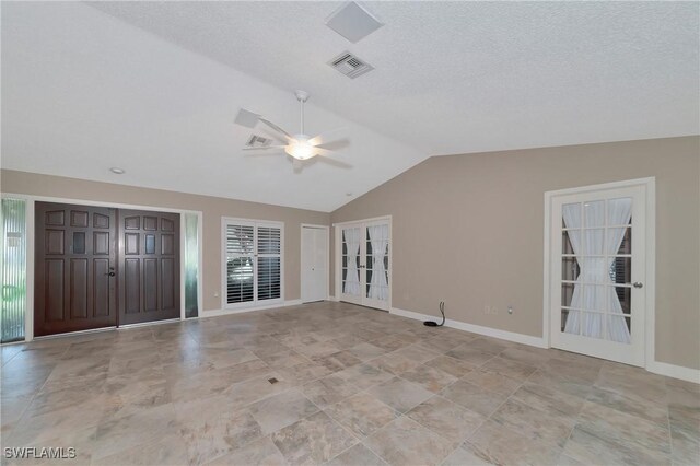 225 Brighton Ct, Englewood, FL 34223 - unfurnished living room with vaulted ceiling, a ceiling fan, visible vents, and baseboards