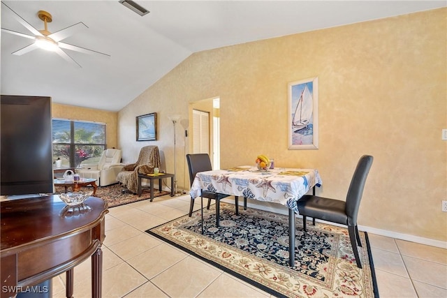 dining area with vaulted ceiling, a textured wall, visible vents, a ceiling fan, and light tile patterned flooring
