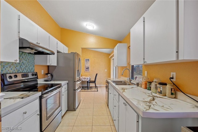 kitchen featuring decorative backsplash, a sink, stainless steel appliances, under cabinet range hood, and vaulted ceiling