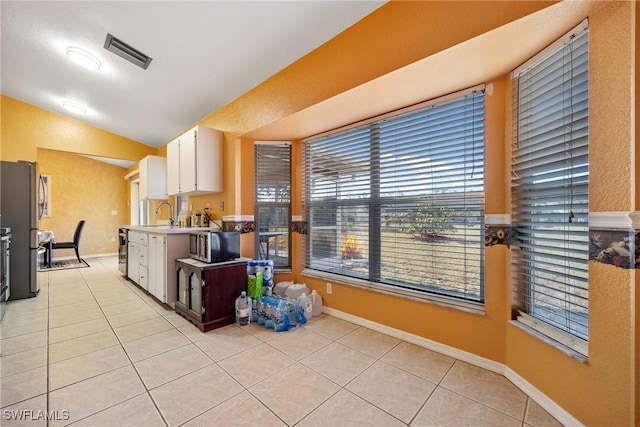kitchen featuring light tile patterned floors, visible vents, appliances with stainless steel finishes, and light countertops