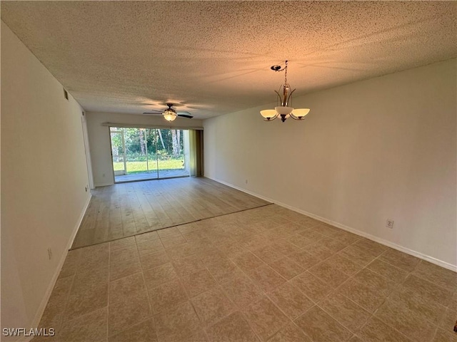 unfurnished room with a textured ceiling, baseboards, and ceiling fan with notable chandelier