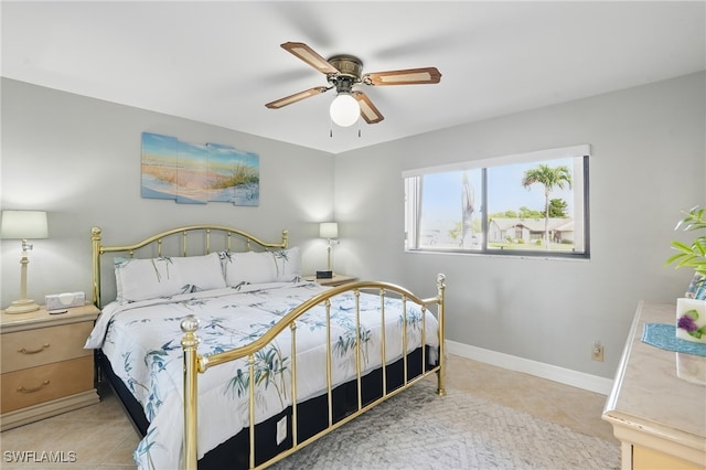 4321 Country Club Blvd Unit 102, Cape Coral, FL 33904 - bedroom with tile patterned flooring, baseboards, and a ceiling fan