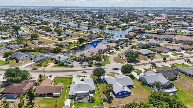 4321 Country Club Blvd Unit 102, Cape Coral, FL 33904 - aerial view of property and surrounding area with nearby suburban area and a large body of water
