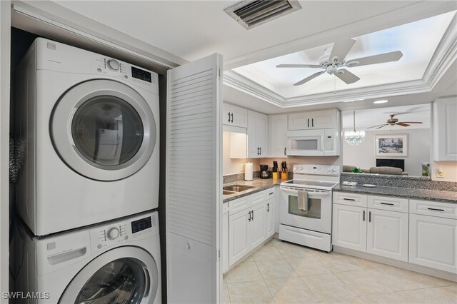 4321 Country Club Blvd Unit 102, Cape Coral, FL 33904 - clothes washing area with stacked washer / drying machine, a ceiling fan, light tile patterned flooring, and crown molding