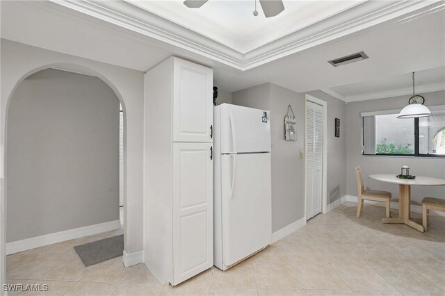 4321 Country Club Blvd Unit 102, Cape Coral, FL 33904 - kitchen with freestanding refrigerator, crown molding, arched walkways, light tile patterned flooring, and a ceiling fan