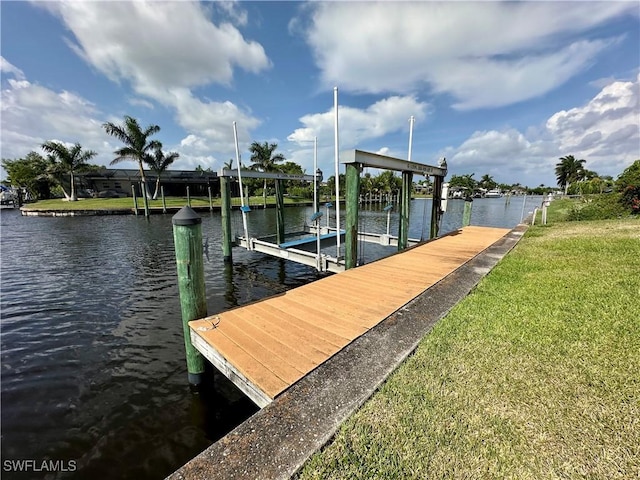 4343 S Gulf Cir, North Fort Myers, FL 33903 - dock area with boat lift, a water view, and a lawn