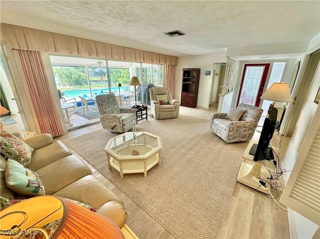 4343 S Gulf Cir, North Fort Myers, FL 33903 - living room with a textured ceiling and light wood-type flooring