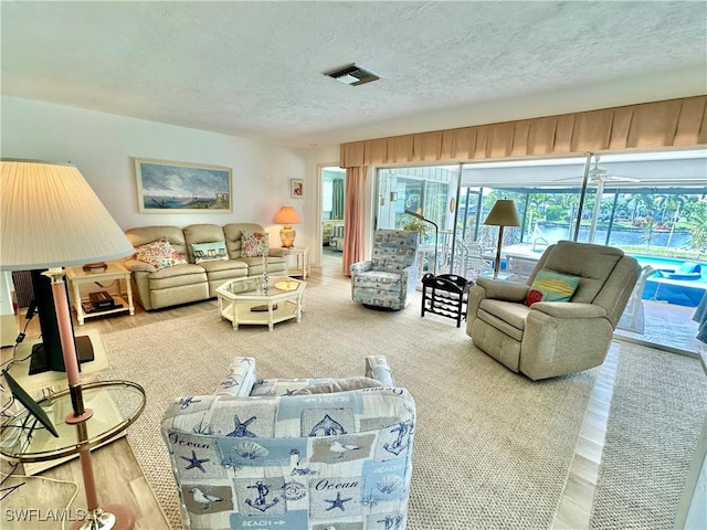 4343 S Gulf Cir, North Fort Myers, FL 33903 - living room featuring a textured ceiling and wood finished floors