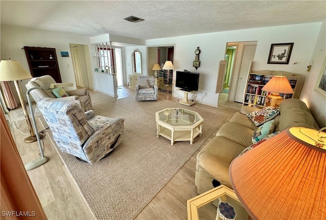 4343 S Gulf Cir, North Fort Myers, FL 33903 - living room featuring wood finished floors and a textured ceiling