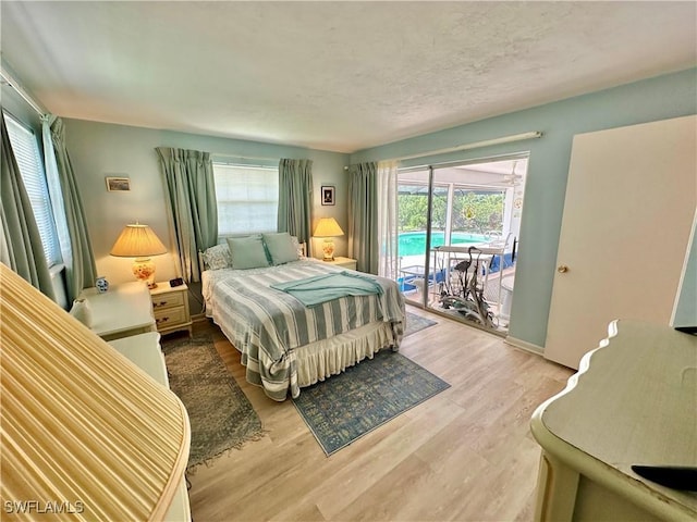 4343 S Gulf Cir, North Fort Myers, FL 33903 - bedroom with access to exterior, multiple windows, and wood finished floors