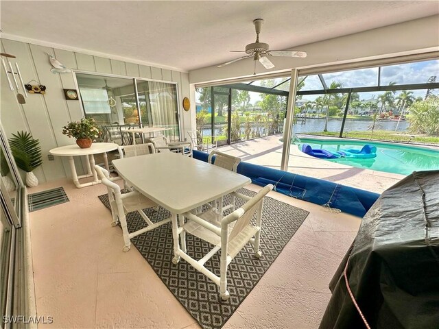 4343 S Gulf Cir, North Fort Myers, FL 33903 - sunroom featuring a water view, a ceiling fan, and outdoor dining area