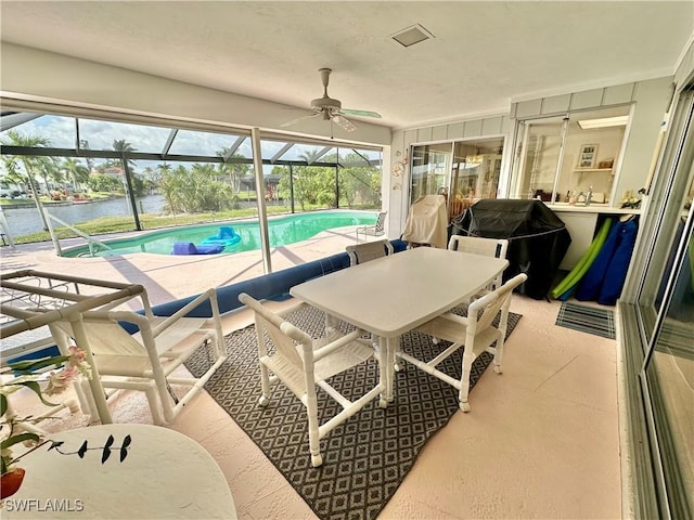 4343 S Gulf Cir, North Fort Myers, FL 33903 - sunroom with a ceiling fan, a swimming pool, and a water view