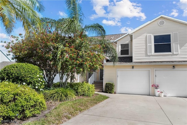 view of property featuring driveway and an attached garage