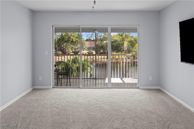 unfurnished room featuring baseboards and carpet flooring
