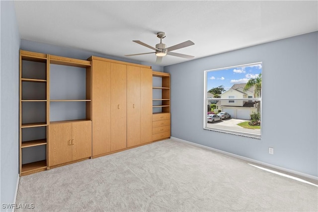 unfurnished bedroom featuring ceiling fan, baseboards, carpet flooring, and a closet