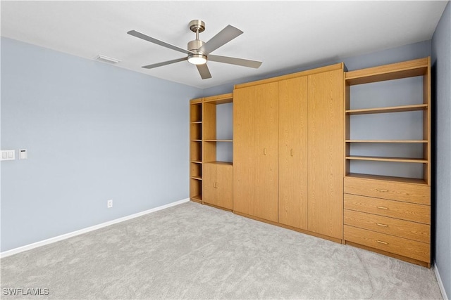 unfurnished bedroom featuring visible vents, a closet, baseboards, carpet floors, and a ceiling fan