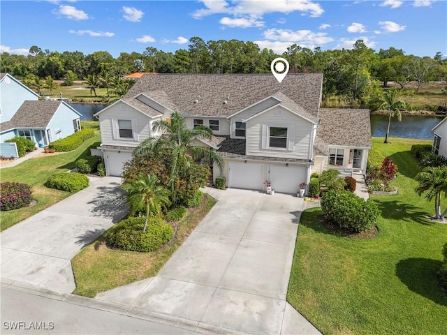 view of front facade featuring a front yard, a garage, a shingled roof, a water view, and concrete driveway