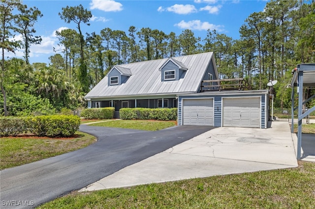 4925 Boxwood Way, Naples, FL 34116 - view of front of house with driveway, an attached garage, metal roof, and fence