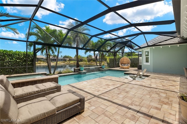 pool with glass enclosure, a patio area, an in ground hot tub, and a water view