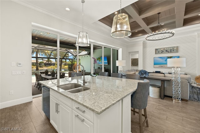 kitchen with coffered ceiling, open floor plan, a sink, and beam ceiling