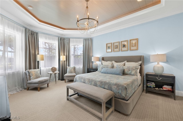 bedroom with a tray ceiling, carpet flooring, and ornamental molding