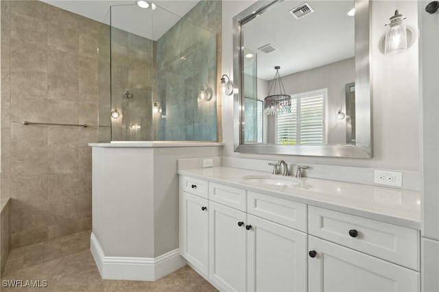 6348 Lyford Isle Dr, Naples, FL 34113 - bathroom with a walk in shower, vanity, tile patterned flooring, and a chandelier