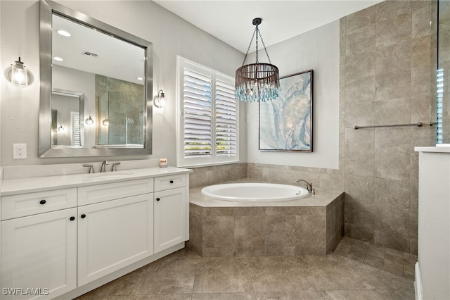 6348 Lyford Isle Dr, Naples, FL 34113 - bathroom featuring vanity, a garden tub, and a chandelier