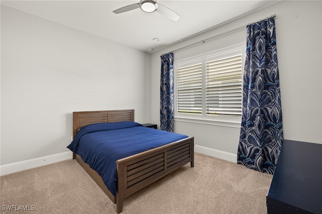 bedroom with carpet floors, a ceiling fan, and baseboards