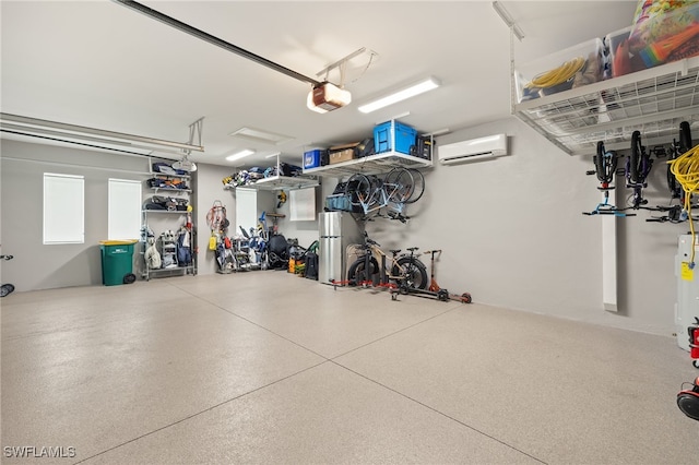 garage with a garage door opener and a wall unit AC