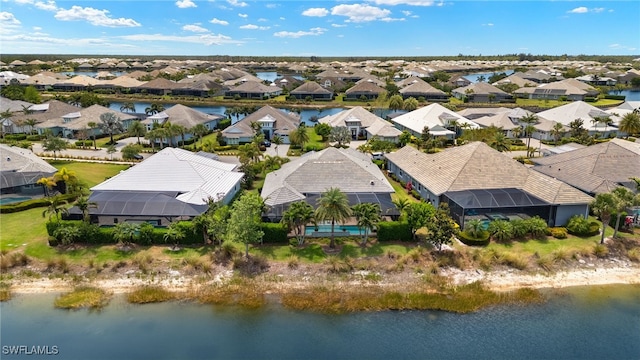 birds eye view of property with a residential view and a water view