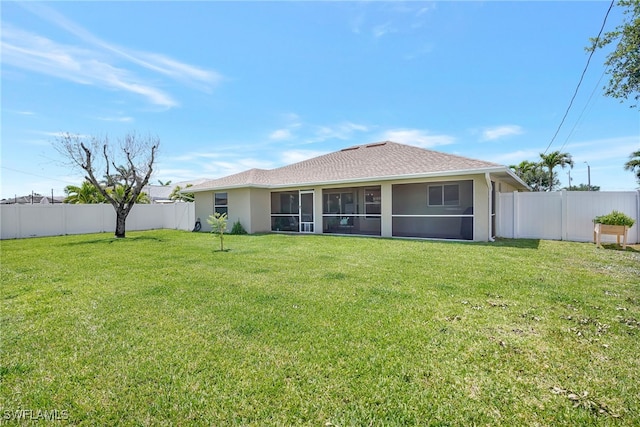 4105 SW 9th Ave, Cape Coral, FL 33914 - rear view of property featuring a sunroom, a fenced backyard, and stucco siding