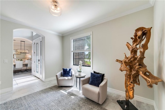 19128 Elston Way, Estero, FL 33928 - sitting room with crown molding, arched walkways, and baseboards