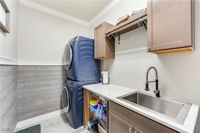 19128 Elston Way, Estero, FL 33928 - washroom featuring stacked washer / drying machine, cabinet space, ornamental molding, and a wainscoted wall