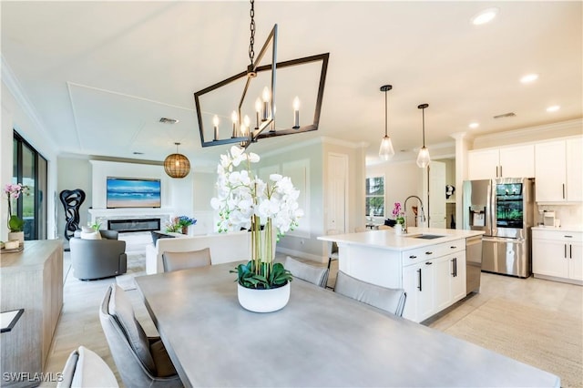19128 Elston Way, Estero, FL 33928 - dining area featuring ornamental molding, a glass covered fireplace, recessed lighting, and a chandelier
