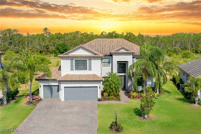 19128 Elston Way, Estero, FL 33928 - mediterranean / spanish house with a tiled roof, stucco siding, decorative driveway, and a front lawn