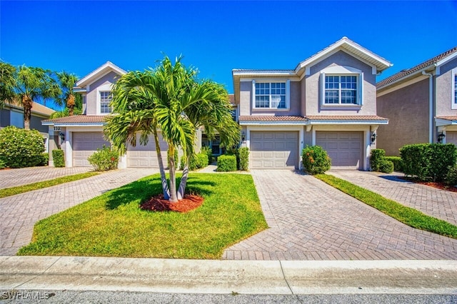 11029 Mill Creek Way Unit 406, Fort Myers, FL 33913 - traditional-style house featuring stucco siding, decorative driveway, a garage, and a tile roof